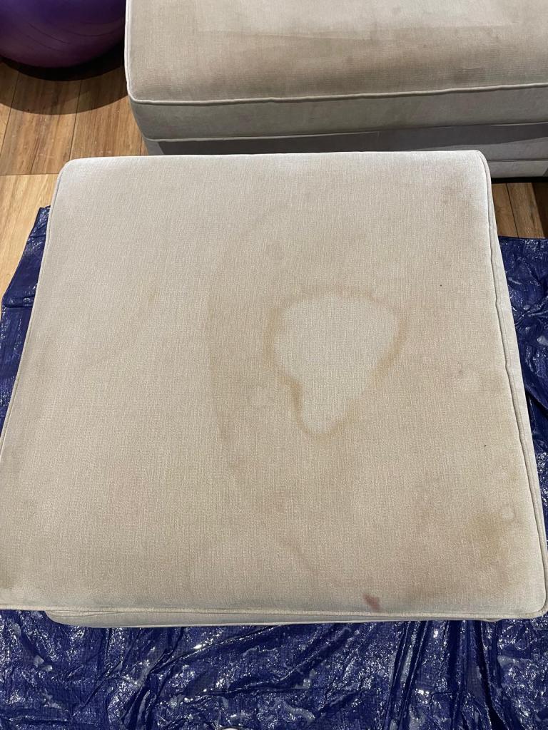 light coloured sofa cushion before cleaning with visible dirty water mark