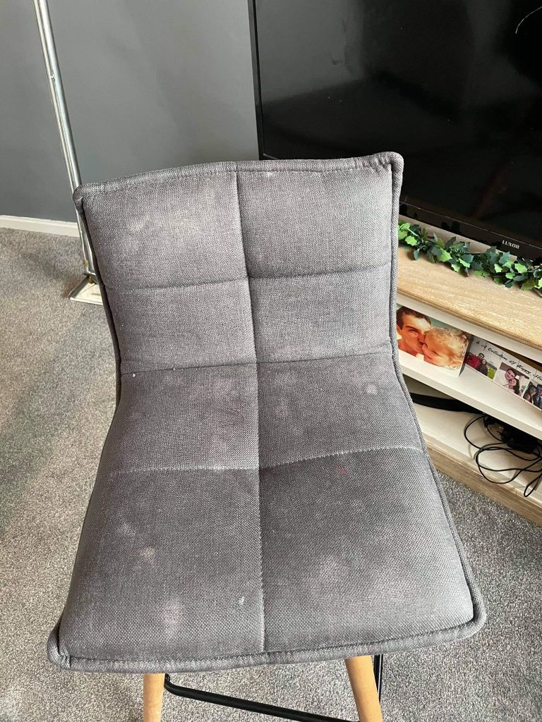 grey fabric dining chair showing visible marks before cleaning