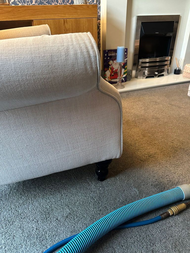 side of a light coloured fabric sofa showing after cleaning tea stain no longer visible